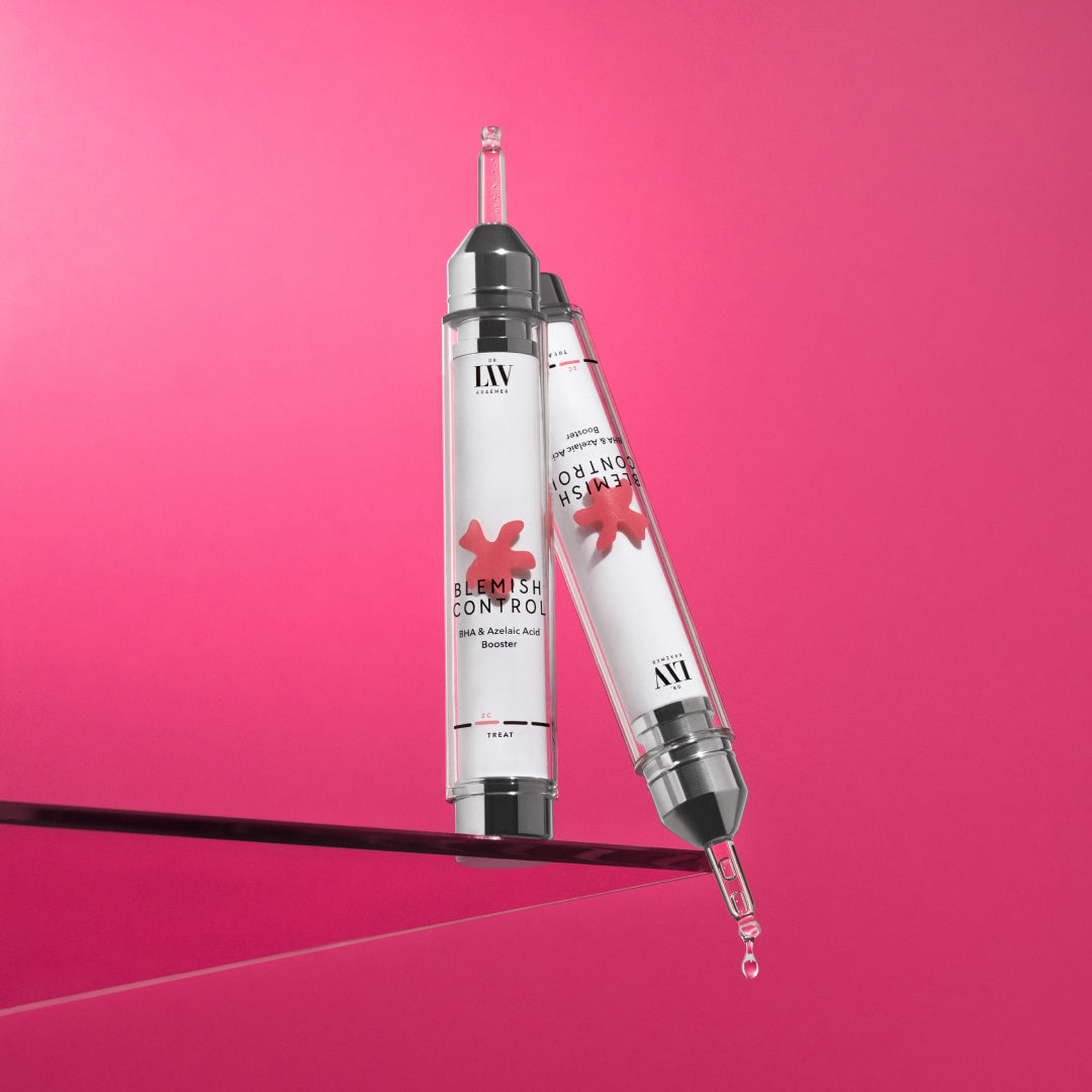 The Blemish Control booster serum developed by board certified dermatologist and skin longevity expert Dr. Liv Kraemer for pimple and blemish prone skin standing on glass, in front of pink background.