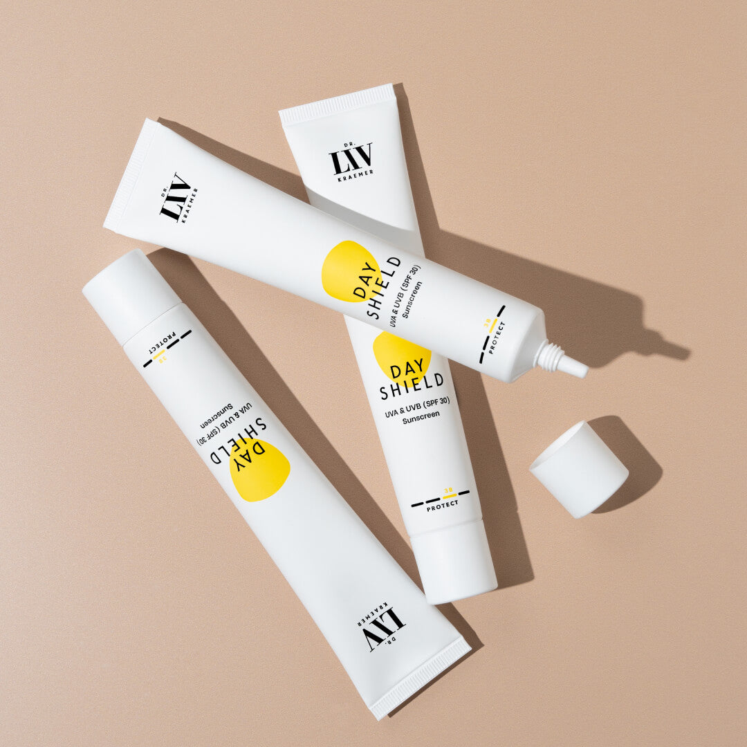 The Day Shield UVA&UVB (SPF 30) Sunscreen developed by board certified dermatologist and skin longevity expert Dr. Liv Kraemer in front of a beige background