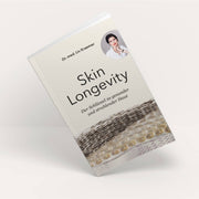 'Skin Longevity' Book by board certified dermatologist and skin longevity expert Dr. Liv Kraemer against an off-white background