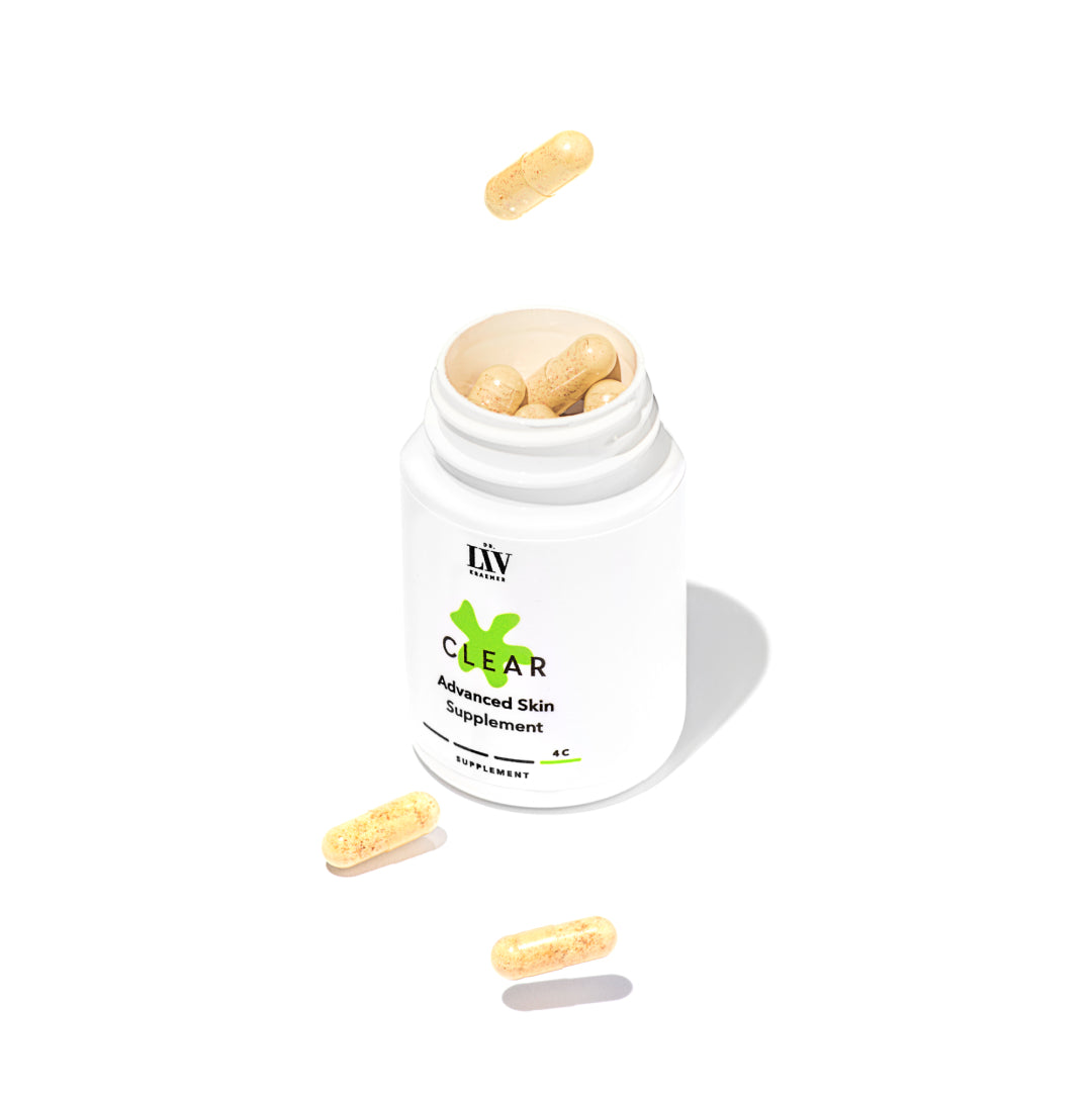 The Clear Advanced Skin Supplement bottle with an open lid showing the orange capsules developed by board certified dermatologist and skincare longevity expert Dr. Liv Kraemer in front of a white background
