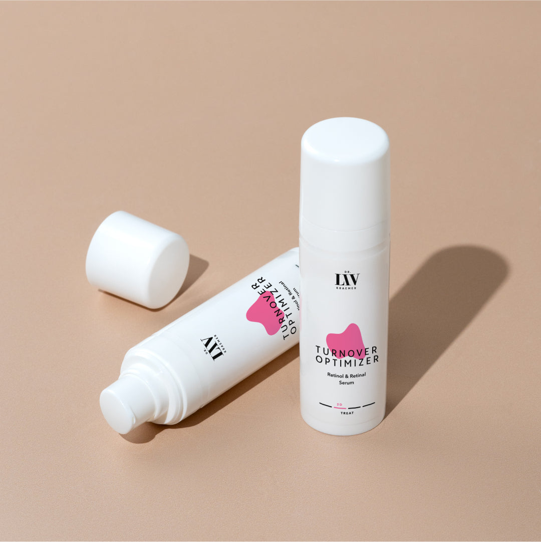 A standing bottle and a lying bottle of the Turnover Optimizer Retinol & Retinal Serum developed by board certified dermatologist and skincare longevity expert Dr. Liv Kraemer, against a beige background.